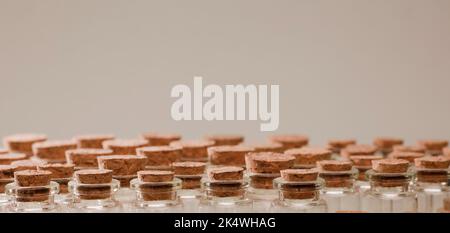 glass jars with corks, soft green background Stock Photo