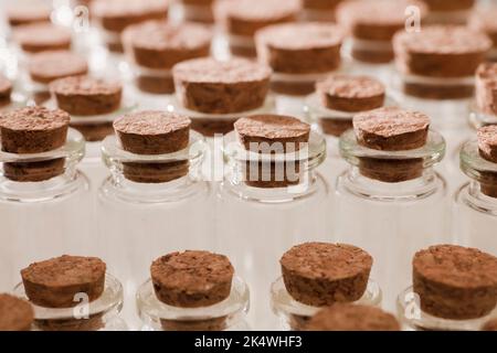 glass jars with corks, soft green background Stock Photo