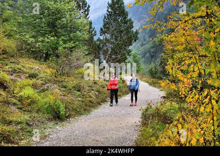 PYRENEES, SPAIN - SEPTEMBER 25, 2021: Hikers enjoy a hiking trail in Ordesa y Monte Perdido National Park in Pyrenees. Stock Photo