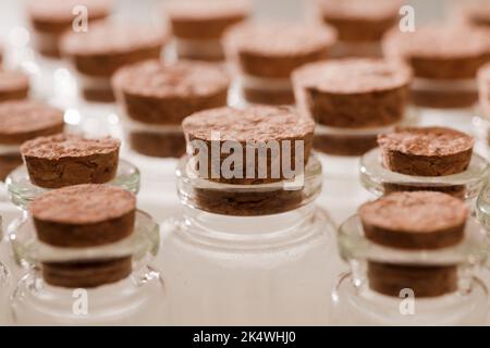 glass jars with corks, soft green background Stock Photo
