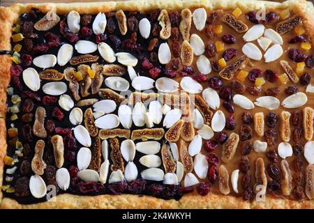Easter cake in Poland. Easter pastry: mazurek cake decorated with almonds and dried fruit. Easter in Poland - Wielkanoc. Stock Photo