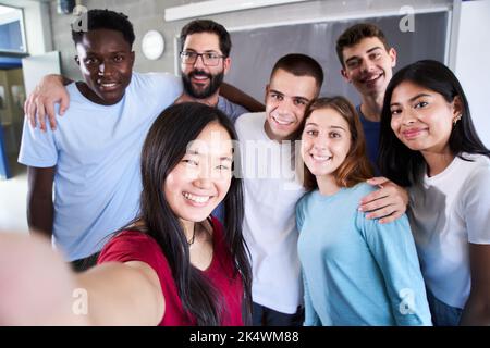 Portrait of a cheerful multiracial group of friends taking a selfie - New concept of normal friendship with young happy people looking at the camera Stock Photo