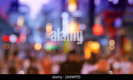 Big city lights - defocused shopping street in Cologne city, Germany. Blurred neons. Stock Photo