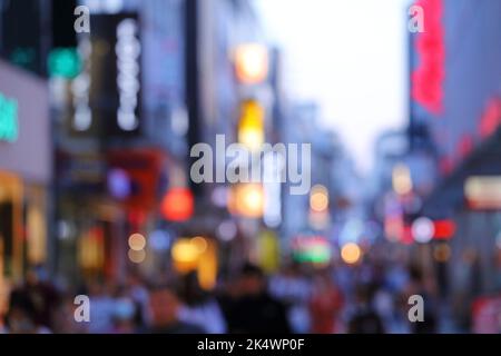 Neon city lights - defocused shopping street in Cologne city, Germany. Blurred neons. Stock Photo