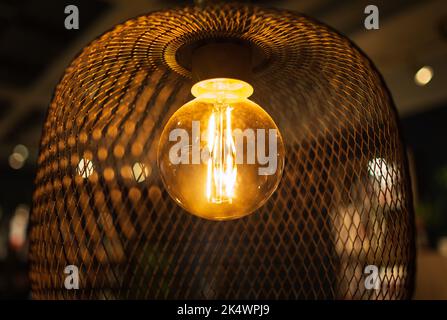 Bamboo pendant light. Wicker handmade chandelier lamps on the wooden ceiling. Eco natural trendy style. Modern minimal interior design. Nobody, select Stock Photo