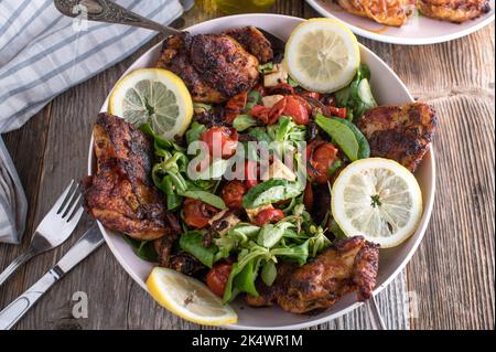 Roast chicken carved  and served with salad with roasted vegetables and feta cheese Stock Photo