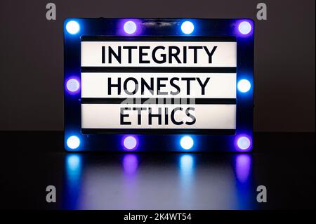 Lightbox with blue lights in dark room with words - integrity, honesty, ethics. Stock Photo