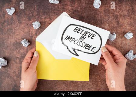 Handwriting text Believe In Impossible. Internet Concept motivation and inspiration that you can make it happen Stock Photo