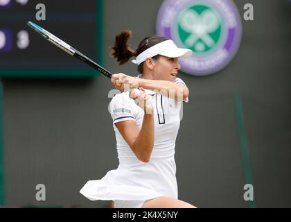 Australian tennis player Ajla Tomljanovic playing forehand shot during Wimbledon Championships 2022, London, England, United Kingdom Stock Photo