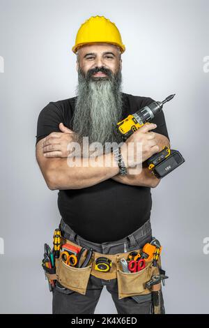 smiling worker with crossed arms and , long beard. Stock Photo