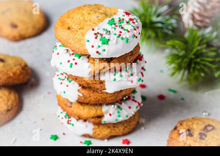 Stack of Christmas cookies with white frosting and holiday sprinkles. Stock Photo