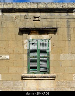 Closed window of the old building covered by green wooden blinds in Rabat town on Malta Stock Photo