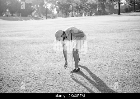 man playing game on green grass taking ball. summer activity. professional sport outdoor Stock Photo