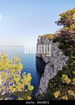 The Dugi Otok Cliffs in Telascica Nature Park, Croatia in the water, vertical shot Stock Photo