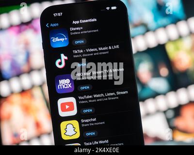 Galati, Romania - October, 03 2022: Mobile app icons of App Essentials from Apple App Store are seen on an iPhone 14 Pro, including Disney+, TikTok, H Stock Photo