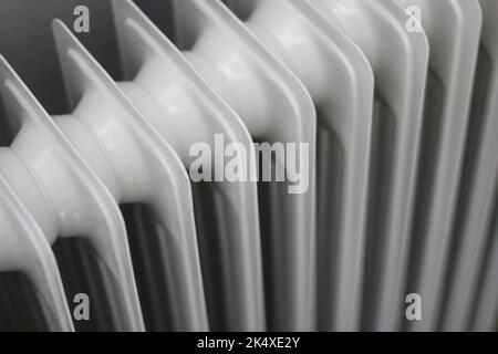Full frame background of old fashioned grey metal radiator showing fin detail Stock Photo