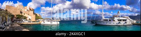 Calvi town, Corsica. Panorama of marine with sailing boats and medieval fortess. France Stock Photo