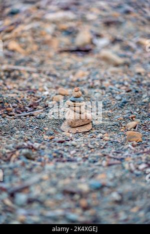 A stone cairn in equilibrium on a Canadian lake beach Stock Photo