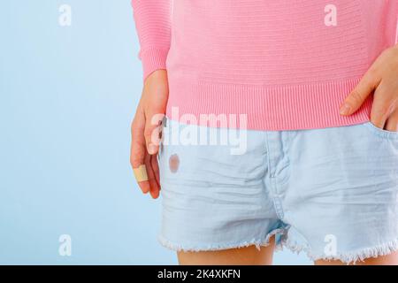 dirty blood stain on clothes. The concept of cleaning stains on clothes.  Isolated on a blue background Stock Photo - Alamy