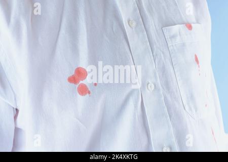 dirty blood stain on clothes. The concept of cleaning stains on clothes.  Isolated on a blue background Stock Photo - Alamy