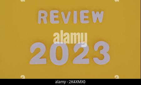 2023 review new year. on a yellow background Review 2023. Business, new year 2023 review concept. copy space. Stock Photo