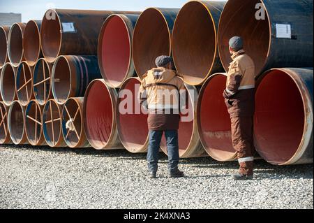 A Line of oilfield large streel pipes in industrial construction area Stock Photo