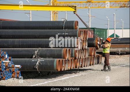 A Line of oilfield large streel pipes in industrial construction area Stock Photo