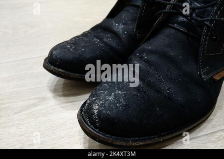 Black shoes, covered in mud, isolated on white Stock Photo - Alamy
