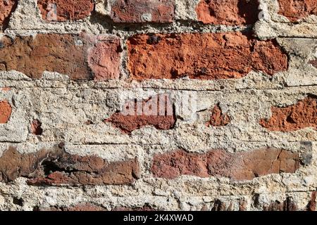 Full frame dark coarse brick wall background with lots of mortar Stock Photo