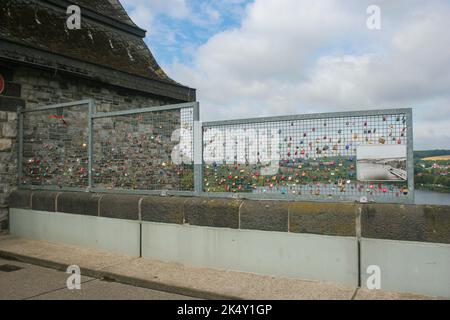 Numerous padlocks on the grid of a fence in a tourist location. Couples hang these so-called love locks as a symbol for their relationship. Stock Photo