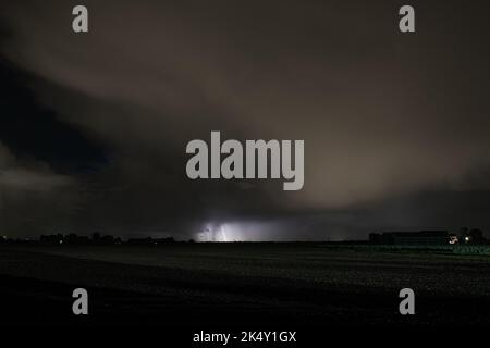 Nighttime image of an autumn thunderstorm over the fields of the Netherlands Stock Photo