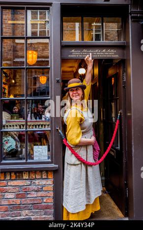 The York Ghost Merchant female business owner standing outside the ghost shop in the Shambles, York, Yorkshire, England. Stock Photo