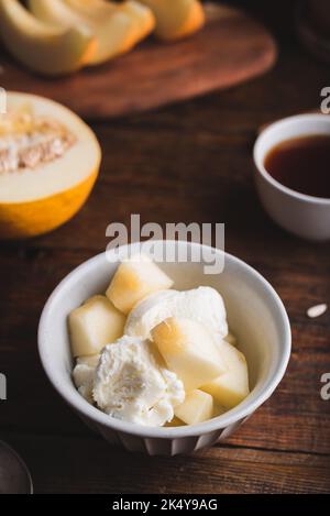 Vanilla Ice Cream with Slices of Honeydew Melon in Bowl Stock Photo