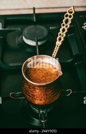 Brewing Coffee in Traditional Pot on a Gas Stove Stock Photo
