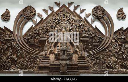 Handicrafts of teak wood carving reliefs of Angkor Wat. The panel is carved from wood, Abstract architecture art,  Selective focus. Stock Photo