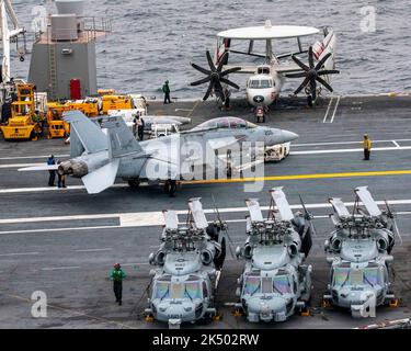 ATLANTIC OCEAN (Nov. 13, 2020) Sailors assigned to the aircraft carrier USS Gerald R. Ford (CVN 78) air department tow an F/A-18F Super Hornet attached to the “Blacklions” of Strike Fighter Squadron (VFA) 213, Nov. 13, 2020. Under the leadership of Carrier Strike Group (CSG) 12, Gerald R. Ford is underway in the Atlantic Ocean conducting first-ever integrated carrier strike group operations with Carrier Air Wing (CVW) 8, Destroyer Squadron (DESRON) 2 and their air and missile defense commander, the commanding officer of the guided-missile cruiser USS Gettysburg (CG 64). Stock Photo