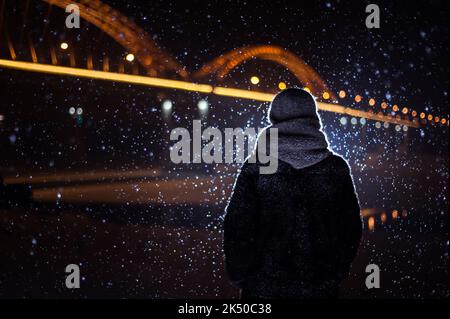 silhouette of a man on the background of falling snow in winter Stock Photo