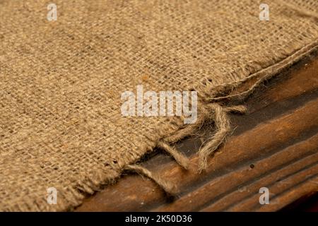 Homespun fabric with a rough texture. Close-up, selective focus. Stock Photo