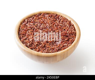Uncooked red rice in wooden bowl isolated on white background with clipping path Stock Photo
