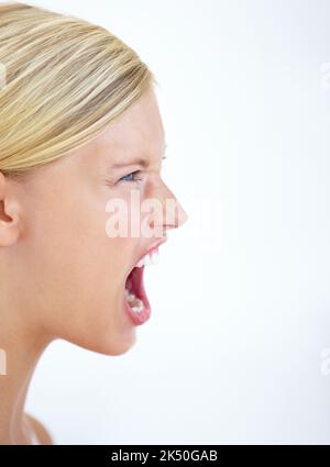 I will be heard. A furious young woman shrieking alongside copyspace. Stock Photo