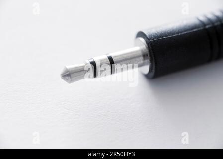 Close-up view of mini jack plug against white background Stock Photo