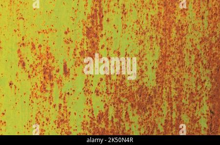 Background and texture of metallic wall. Shabby and scaly backdrop, colored in fiery yellow color. Old rusty metal surface with faded uneven color Stock Photo