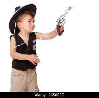 Pretending to be a cowboy. A cute little boy pretending to be a cowboy. Stock Photo