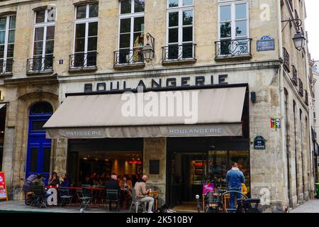 People sitting outside cafe, boulangerie, eating and drinking, in the 4th Arrondissement, Marais, Paris, France. Stock Photo