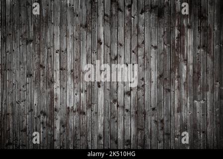 Dark gray weathered old wooden wall background from planks with nails Stock Photo