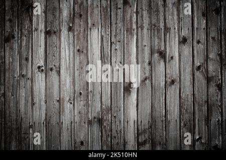 Old dark gray rustic wooden wall background planks weathered with nails Stock Photo