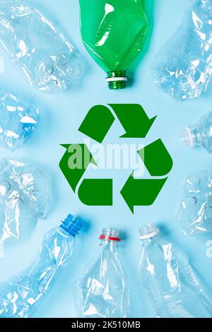 Plastic bottles with recycling symbol on blue background top view Stock Photo
