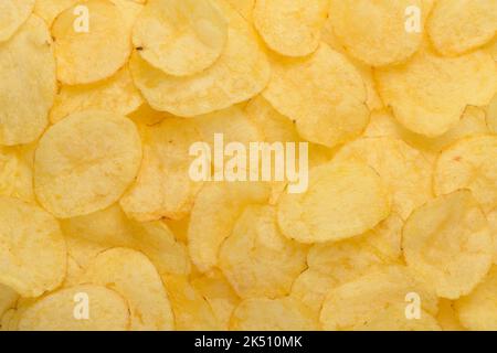 Crispy potato chips with salt texture top view pattern background Stock Photo