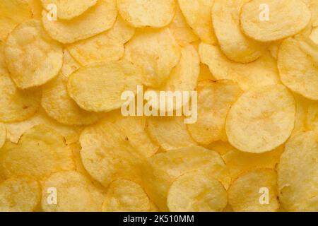 Potato chips with salt texture top view pattern background Stock Photo