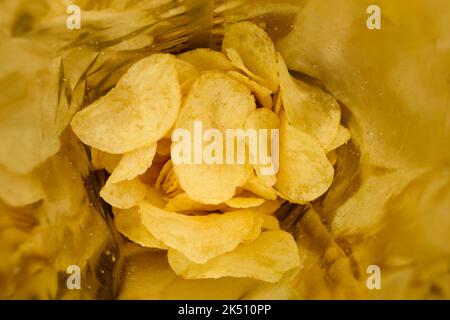 Crispy potato chips with salt inside foil bag package Stock Photo